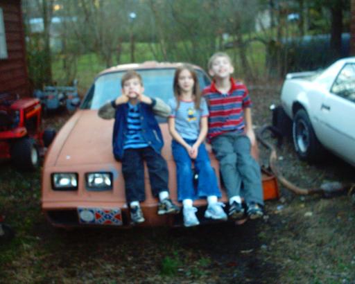 My kids and "Rusty". As you can see the little one is a bit of a comic. He is also a future "Bandit" owner. The older boy wants a Knight 2000 and my daughter wants my car!