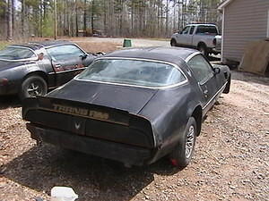 I added the black spoiler that i had in storage...and replaced the studs in the corner pieces..........still no back bumper