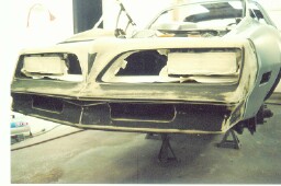 After the mechanical was done, it's off to the paint shop and she's down to the metal.  There was no rust anywhere: trunk, floor pans or on the body.  The trunk still has the factory paint and spare tire.