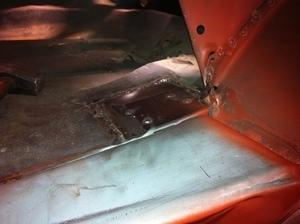 CLose up of the patch i put in the trunk floor over the frame rail support.  This area was a bit pinholed and i decided to repair it now while it was easy to access.  I used a flange weld so it was tidy from below as well.  This is not ground, filled a...